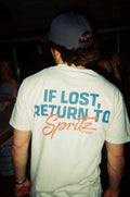 Person wearing a white t-shirt with 'If Lost, Return to Spritz Stuart' text.